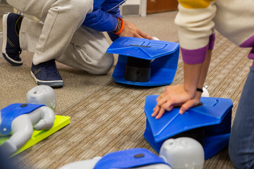 CPR training class by security guard in office