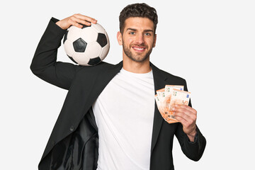 Football and finance: Young businessman with a ball and a wad of euro bills.