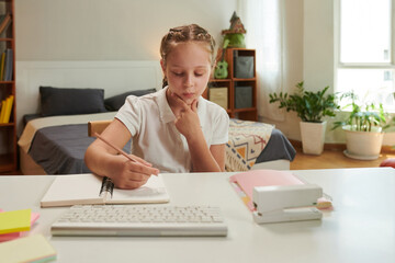 Schoolgirl solving equations when doing math homework