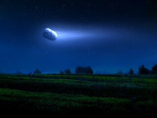 Fototapeta na wymiar Large comet with a long tail in the night sky over green fields. Fantastic landscape with a celestial body.