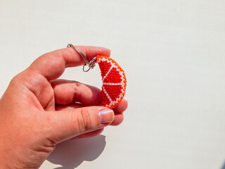 Orange fruit keychain in hand