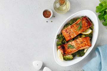 Salmon. Baked, roasted fish steaks, slices. Grilled salmon,trout fillet fish in marinade with broccoli in baking dish. Diet, meal, dinner.