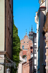 Fototapeta na wymiar Poland, city of Gdansk, Old Town, historic tenement houses with gables. House wall with greenery.
