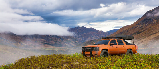 4x4 Offroad Pickup Truck in the Meadows with mountain landscape. 3d Rendering Vehicle Composition. Background Image from Yukon, Canada. © edb3_16
