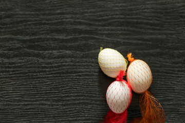 chicken eggs in decorative yellow grids on a dark wooden background. Easter.