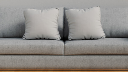 mockup of two white square cushions on a gray sofa
