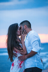 Seaside Love: A Couple Sharing a Romantic Sunset Kiss on the Beach