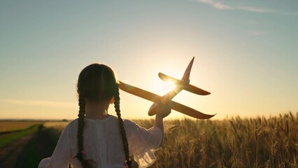 Little girl child wants to become pilot and astronaut. Kid aviator dreams of flying and becoming...