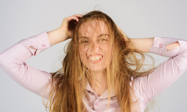 Bad hairs day. Young woman with long disheveled damaged hair. Haircare. Woman having bad messy and tangled hair. Female model with unbrushed dry hair. Hair salon advertising. Shampoo or conditioner.