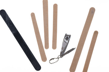metallic nail clipper (with Korea) and out of focus nail files on a white backlit surface