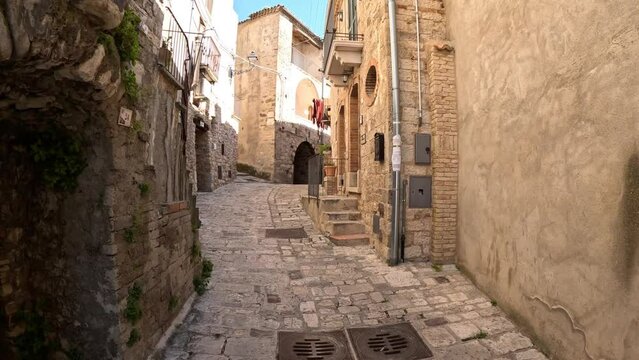 A narrow street among the old houses of Civitacampomarano, a medieval town in the province of Campobasso in Italy.
