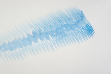 tracing paper with wet blue watercolor paint markings on a backlit surface