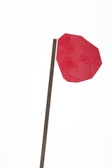 red paper shape with many sides and paper stick on white