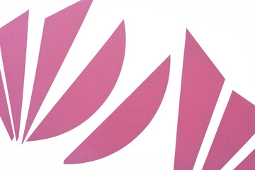 elegant cut pink paper shapes on a white background