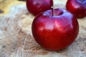 Red apple on wood texture.