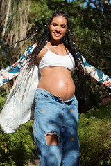 young multiracial pregnant woman full of joy enjoying her pregnancy. Concept of happy and healthy pregnancy