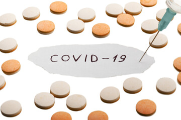 Coronavirus disease named covid 19 handwriting on paper with pill