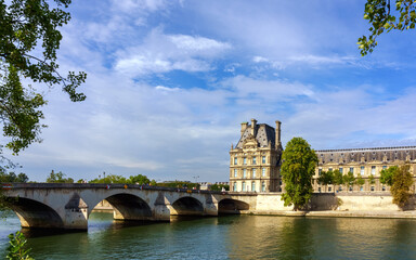 Paris cityscape from Seine river. The bridge Pont Royal, Louvre and embankment.