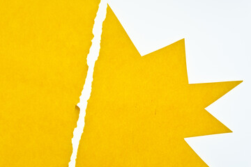 torn and cut yellow paper on white