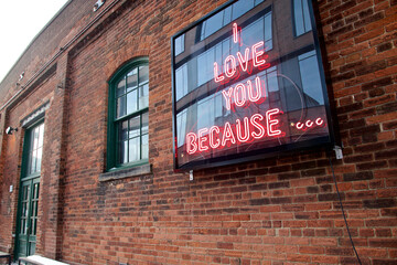 Neon sign on a brick wall. Love concept.