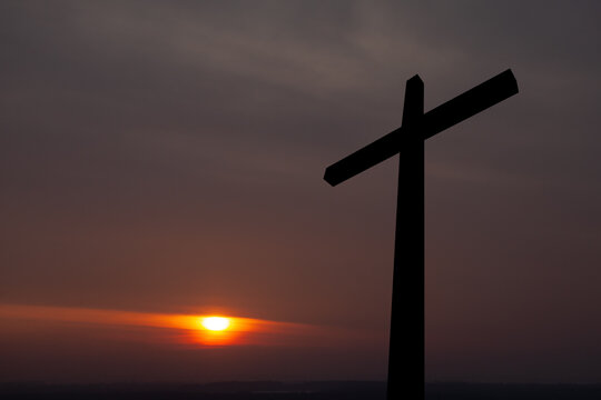 Christian cross at sunrise. Resurrection of Jesus. Concept photo.