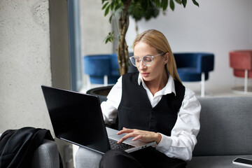 Freelancer copywriter typing on keyboard, planning project at workplace. Beautiful stylish blonde...