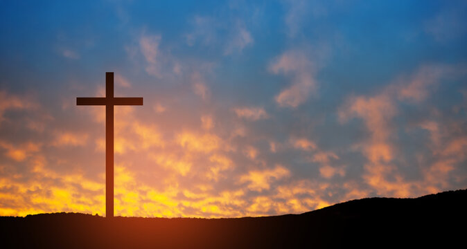 Christian cross on hill outdoors at sunrise. Resurrection of Jesus. Concept photo.