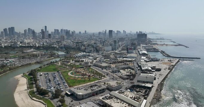 Aerial footage of the Tel Aviv Port Promenade with the Tel Aviv Ramat Gan skyline in the background. Filmed in C4K Apple ProRes 422 HQ