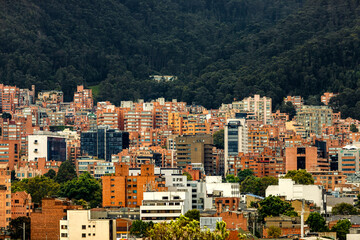Fototapeta na wymiar Residential buildings at the foot of a hill in Bogota, Colombia