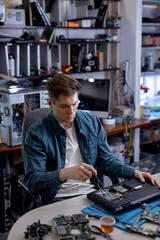 Repairs and diagnostics breakdowns of laptop in professional service center. Professional electronic master in workshop, using different tools or instruments. computer repair concept