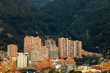 Residential buildings with one under construction at the foot of a hill in Bogota, Colombia