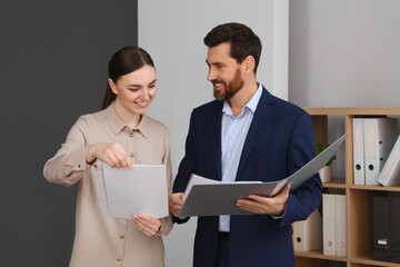 Businesspeople working together with documents in office