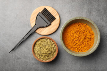 Flat lay composition with henna and turmeric powder on light grey table. Natural hair coloring