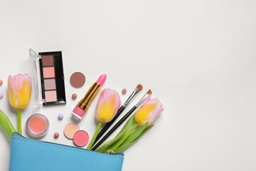 Flat lay composition with different makeup products and beautiful flowers on white background, space for text