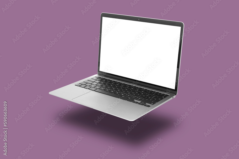 Wall mural one modern laptop flying on pale purple background