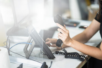 Customer support phone operator in headset Call center worker hand typing on keyboard at desktop...
