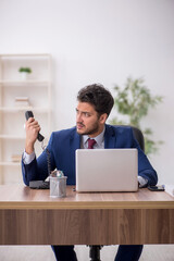 Young male employee working in the office