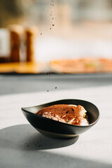 Italian dessert Panna Cotta creamy coffee with chocolate on a plate on a light gray background.