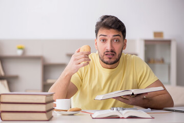 Young male student studying at home