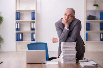 Naklejka premium Old male employee and too much work at workplace