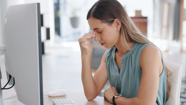 Business woman, headache and stress on computer in burnout, tired or strain at office desk. Exhausted and stressed female employee suffering from bad head pain, ache or migraine by PC at workplace