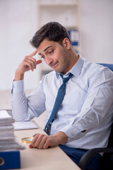 Young male employee working in the office