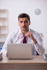 Young male employee working in the office