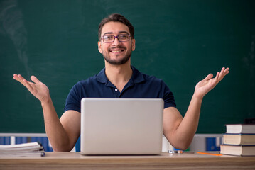 Young male teacher in telestudying concept