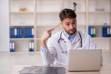 Young male doctor in telemedicine concept