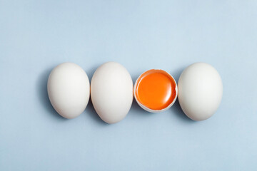 Top view egg yolk and egg white high protein good for body blue background.