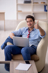 Young male employee sitting in the office