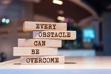 Wooden blocks with words 'Every obstacle can be overcome'. - obrazy, fototapety, plakaty