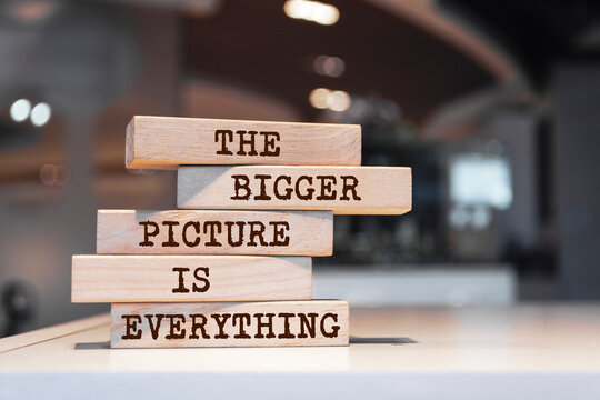 Wooden blocks with words 'The bigger picture is everything'. Motivation concept