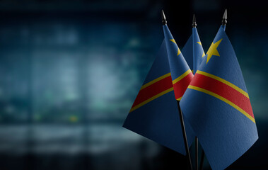 Small flags of the Democratic Republic of the Congo on an abstract blurry background